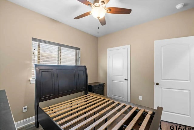 bedroom featuring dark hardwood / wood-style floors and ceiling fan