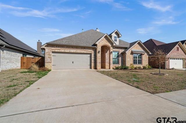 view of front of home featuring a front lawn and a garage