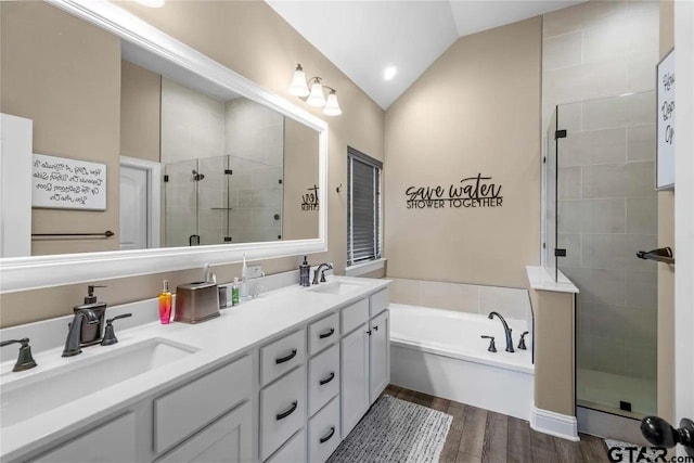 bathroom with vanity, wood-type flooring, vaulted ceiling, and shower with separate bathtub