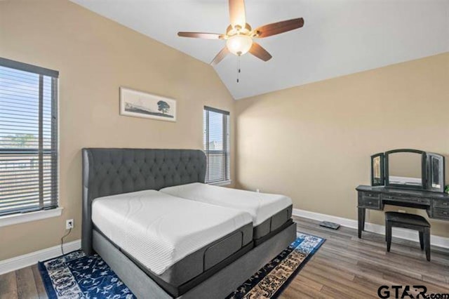 bedroom featuring hardwood / wood-style flooring, ceiling fan, and vaulted ceiling