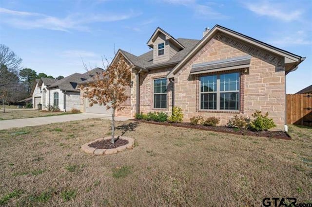 view of front of house with a front yard and a garage