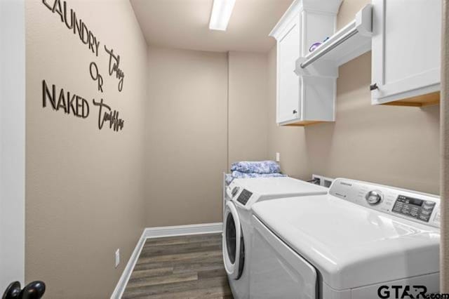 washroom with cabinets, washer and clothes dryer, and dark wood-type flooring