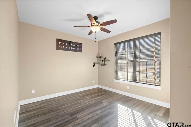 empty room featuring ceiling fan and dark hardwood / wood-style floors