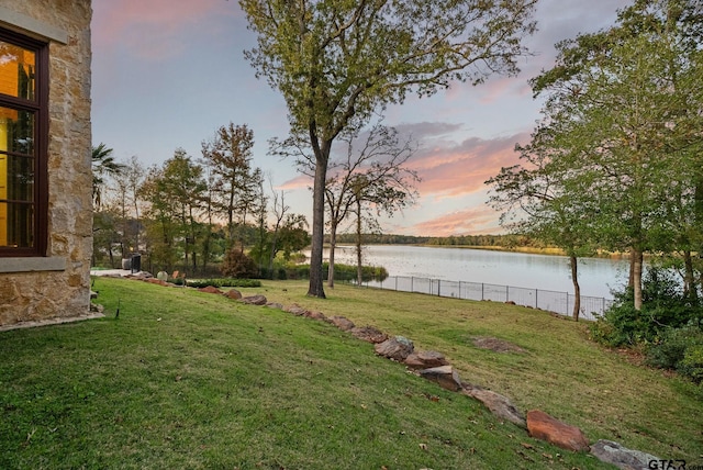 yard at dusk with a water view