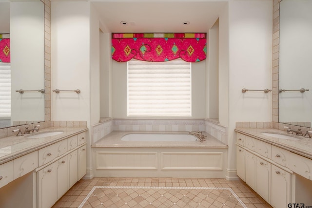 bathroom with tile patterned flooring, a bath, and vanity