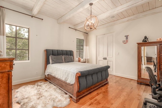 bedroom with beam ceiling, wooden ceiling, light hardwood / wood-style floors, and an inviting chandelier