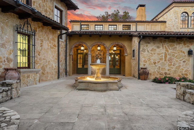 exterior entry at dusk with french doors