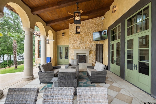 view of patio / terrace with an outdoor living space with a fireplace and french doors