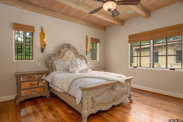 bedroom with beamed ceiling, wood-type flooring, ceiling fan, and wooden ceiling