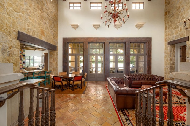4573 Cascades Shoreline Dr, Tyler, TX 75709 - living area featuring a towering ceiling, healthy amount of natural light, french doors, and a chandelier
