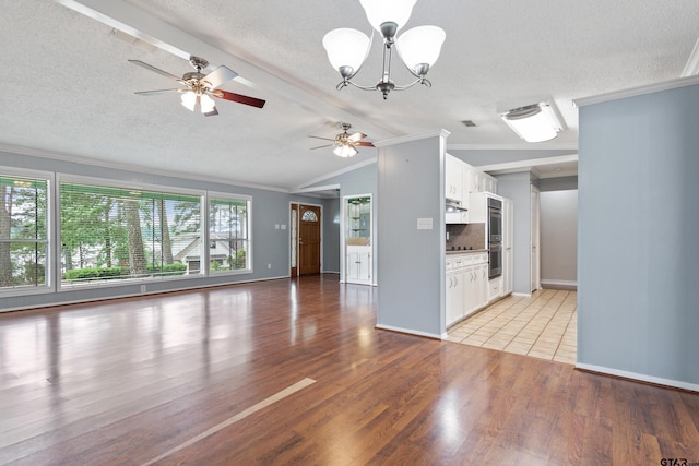 unfurnished living room with crown molding, a textured ceiling, and lofted ceiling with beams