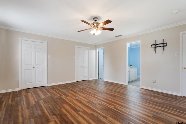 unfurnished bedroom with crown molding, dark wood finished floors, and baseboards