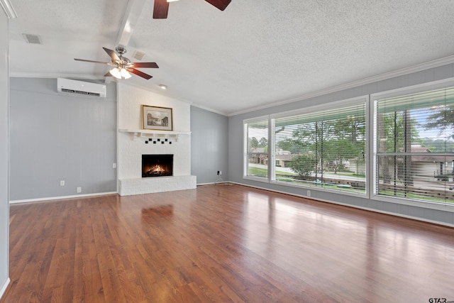 unfurnished living room with ceiling fan, a wall unit AC, vaulted ceiling with beams, visible vents, and ornamental molding