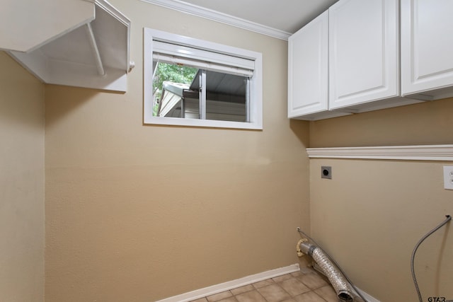 washroom with cabinet space, electric dryer hookup, baseboards, light tile patterned floors, and ornamental molding