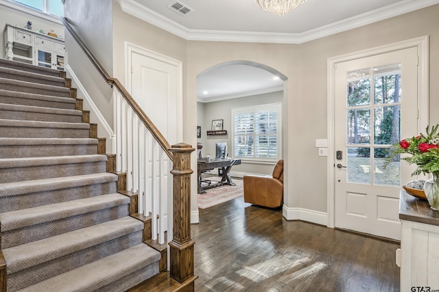 entryway featuring dark wood-style floors, arched walkways, visible vents, and crown molding