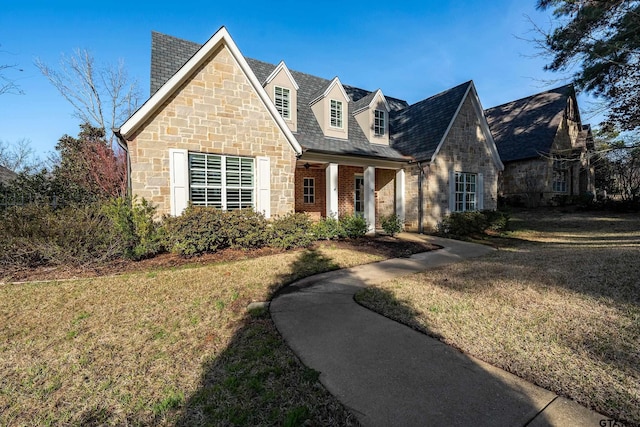 view of front facade featuring a front yard and stone siding