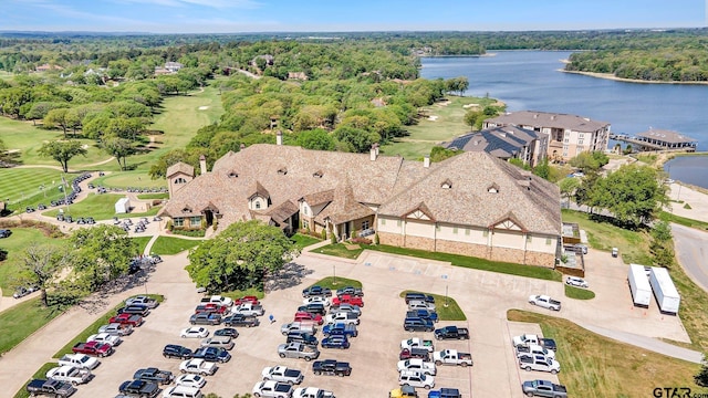 aerial view with a water view and a forest view