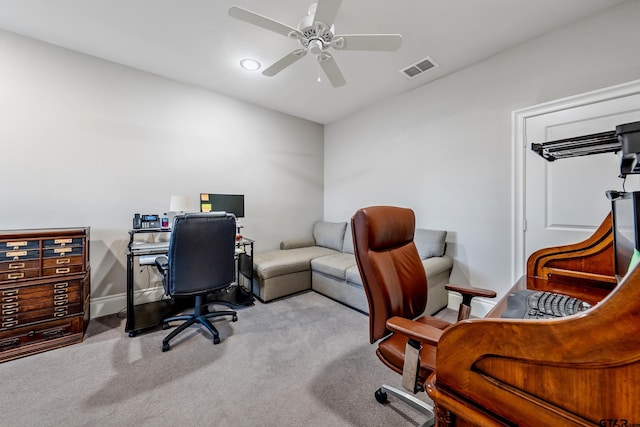 office area with ceiling fan, carpet flooring, visible vents, and baseboards