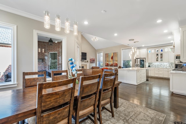 dining space with dark wood-style floors, recessed lighting, crown molding, and vaulted ceiling