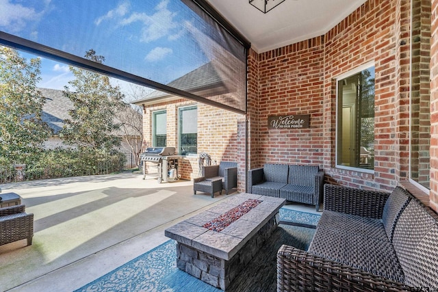 view of patio / terrace with an outdoor living space with a fire pit and area for grilling