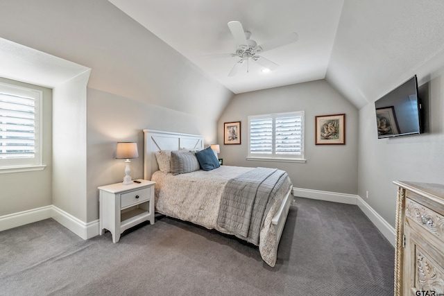 bedroom with dark colored carpet, vaulted ceiling, baseboards, and ceiling fan