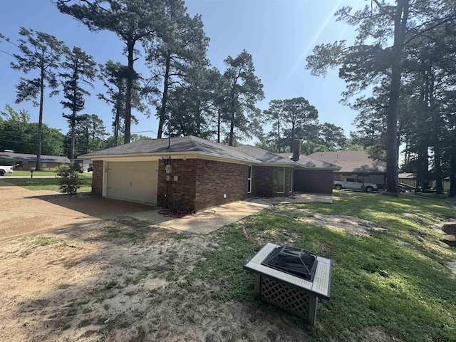 8856 Pleasant Hill Cir, Tyler, TX 75707 - view of side of property featuring concrete driveway, an attached garage, and brick siding