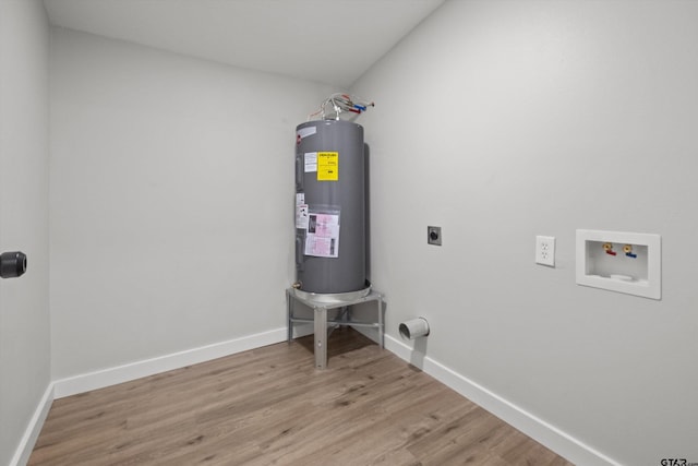 laundry area with electric dryer hookup, electric water heater, washer hookup, and hardwood / wood-style flooring