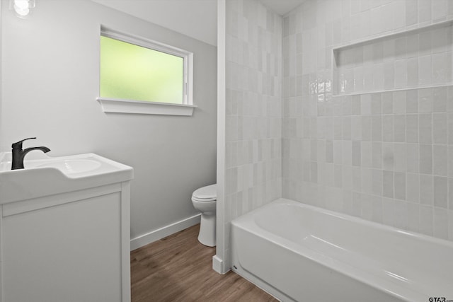 full bathroom with hardwood / wood-style flooring, vanity, toilet, and shower / washtub combination