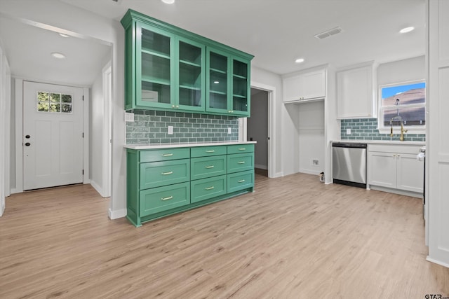 kitchen featuring decorative backsplash, light wood-type flooring, white cabinetry, and stainless steel dishwasher