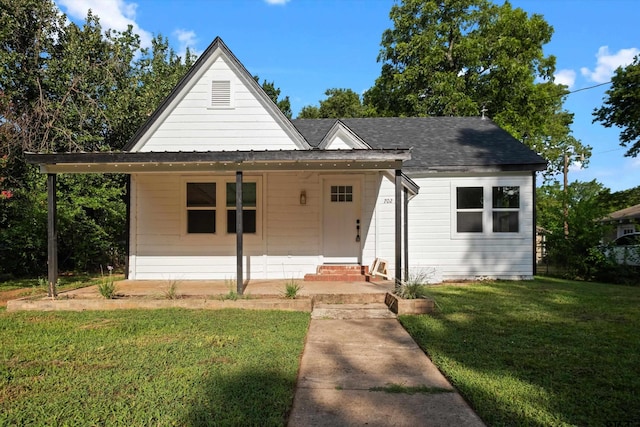 view of front of home featuring covered porch and a front yard