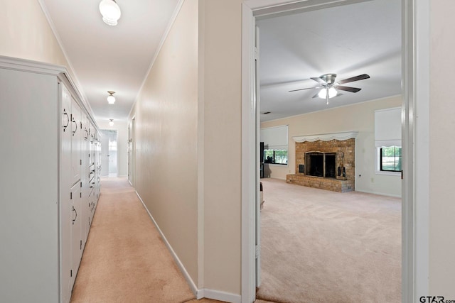 hall featuring light carpet and ornamental molding