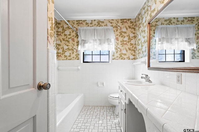 full bathroom featuring toilet, vanity, tile walls, and plenty of natural light