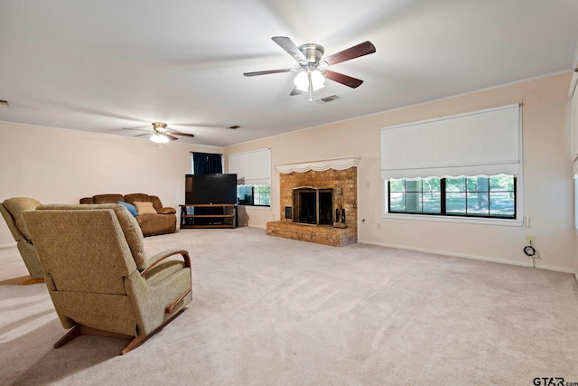 carpeted living room featuring a brick fireplace and ceiling fan