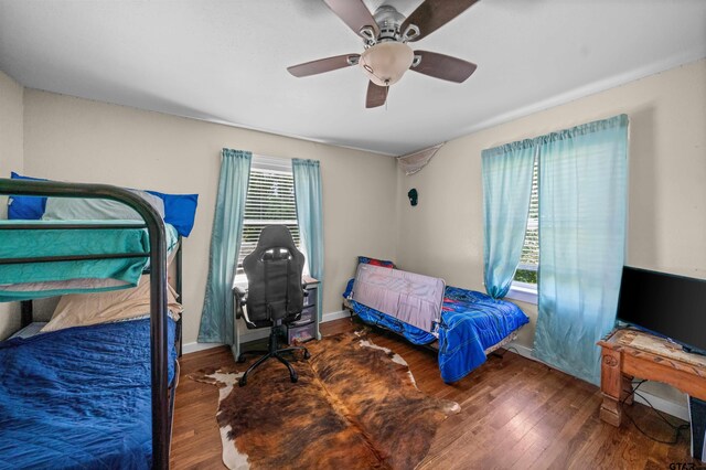 1325 Fm 23 W, Rusk, TX 75785 - bedroom with wood finished floors, baseboards, and ceiling fan