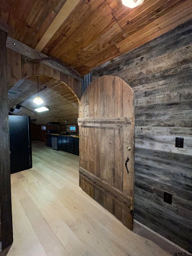 corridor with wood ceiling, wood-type flooring, and wooden walls