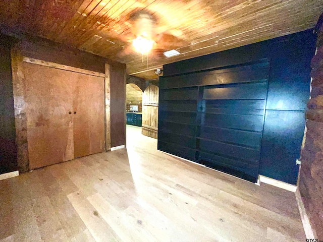 empty room featuring hardwood / wood-style flooring and wooden ceiling