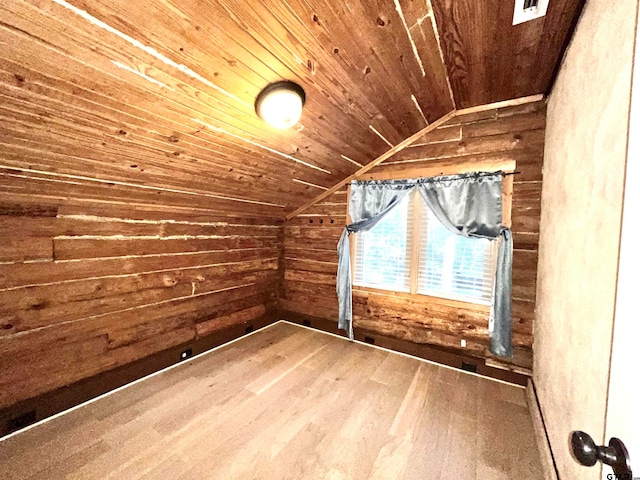 additional living space with vaulted ceiling, wooden walls, hardwood / wood-style floors, and wooden ceiling