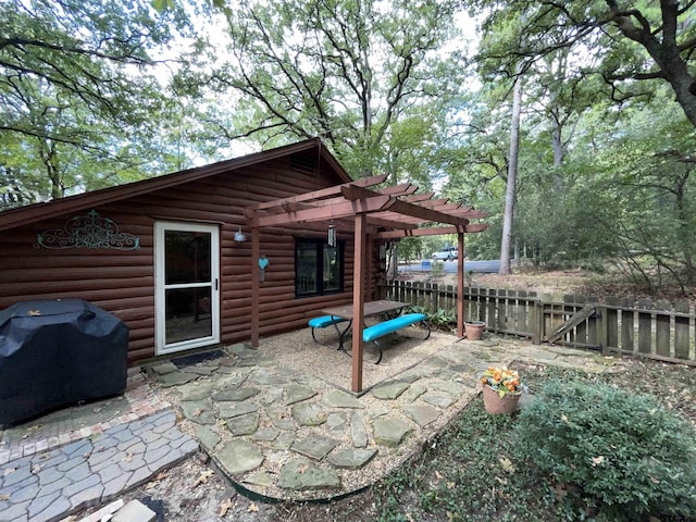 view of patio featuring a grill and a pergola