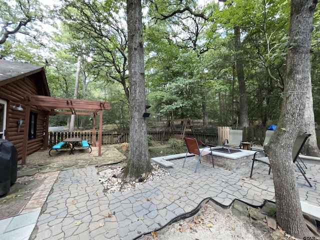 view of patio featuring an outdoor fire pit and a pergola