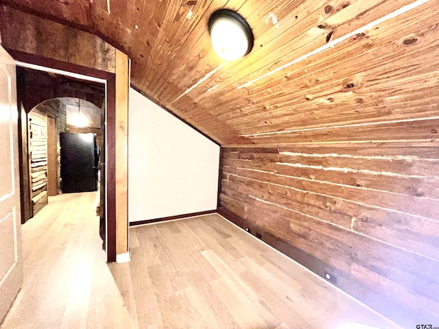 bonus room with vaulted ceiling, wooden walls, light hardwood / wood-style floors, and wooden ceiling