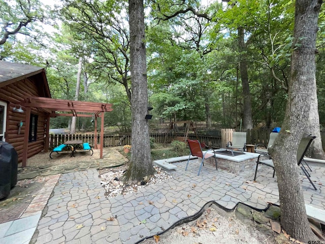 view of patio / terrace featuring an outdoor fire pit and a pergola