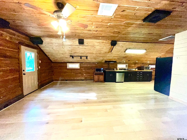 additional living space with wood ceiling, wood-type flooring, vaulted ceiling, and wood walls