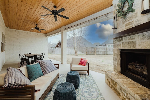 view of patio / terrace with outdoor dining space, an outdoor living space with a fireplace, a fenced backyard, and ceiling fan