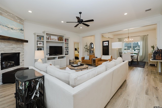 living area with visible vents, ornamental molding, recessed lighting, a fireplace, and light wood-style floors