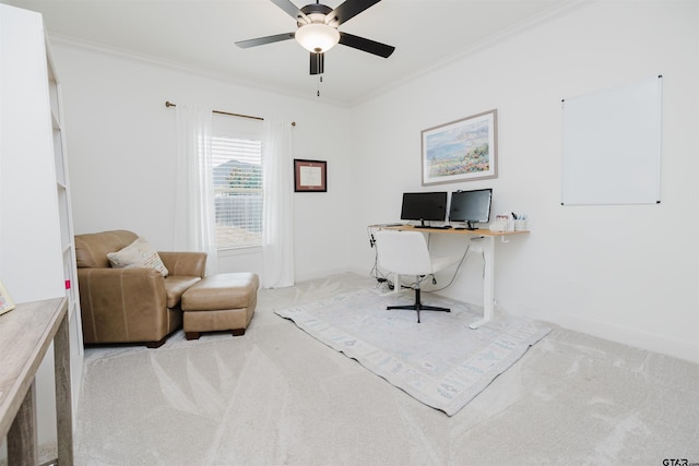 carpeted home office with baseboards, ceiling fan, and crown molding