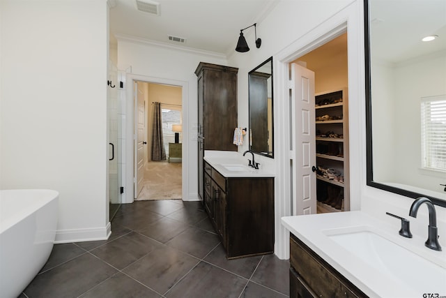 full bathroom with ornamental molding, visible vents, and a sink