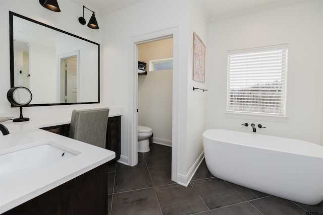 bathroom with tile patterned floors, a freestanding tub, a sink, crown molding, and double vanity