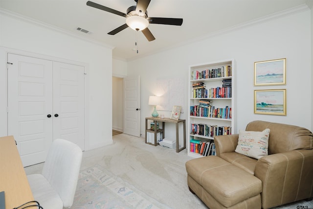 interior space featuring visible vents, a ceiling fan, carpet floors, crown molding, and baseboards