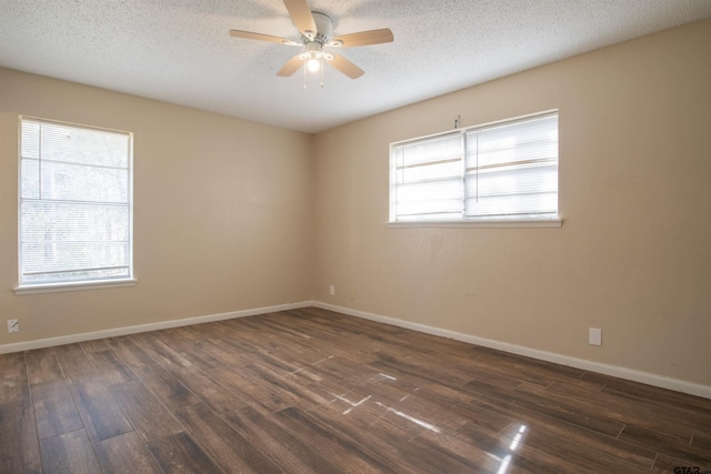 spare room featuring dark hardwood / wood-style floors, a textured ceiling, and ceiling fan