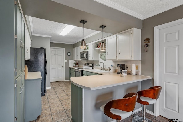 kitchen with white cabinetry, sink, stainless steel appliances, kitchen peninsula, and pendant lighting